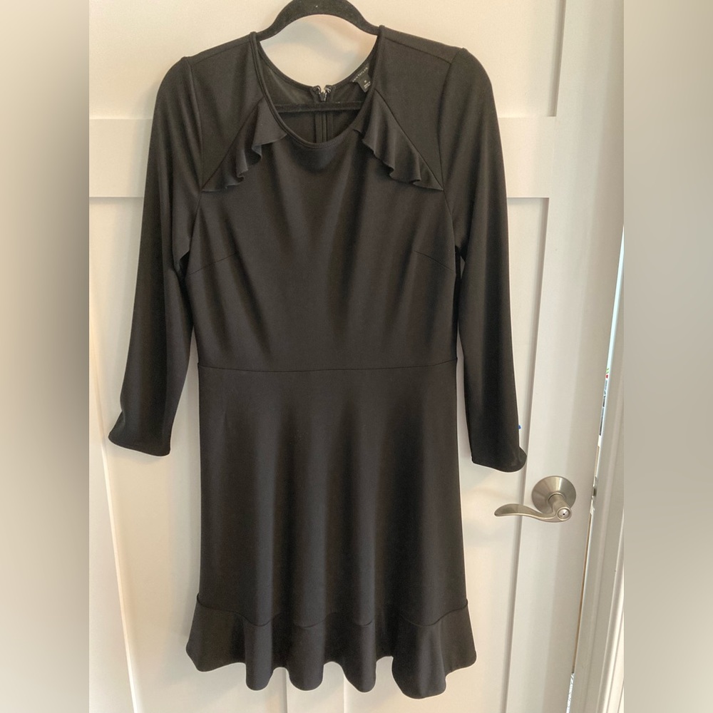 Beautiful black dress from Ann Taylor in size 10. Ruffle detail at neck and hem.